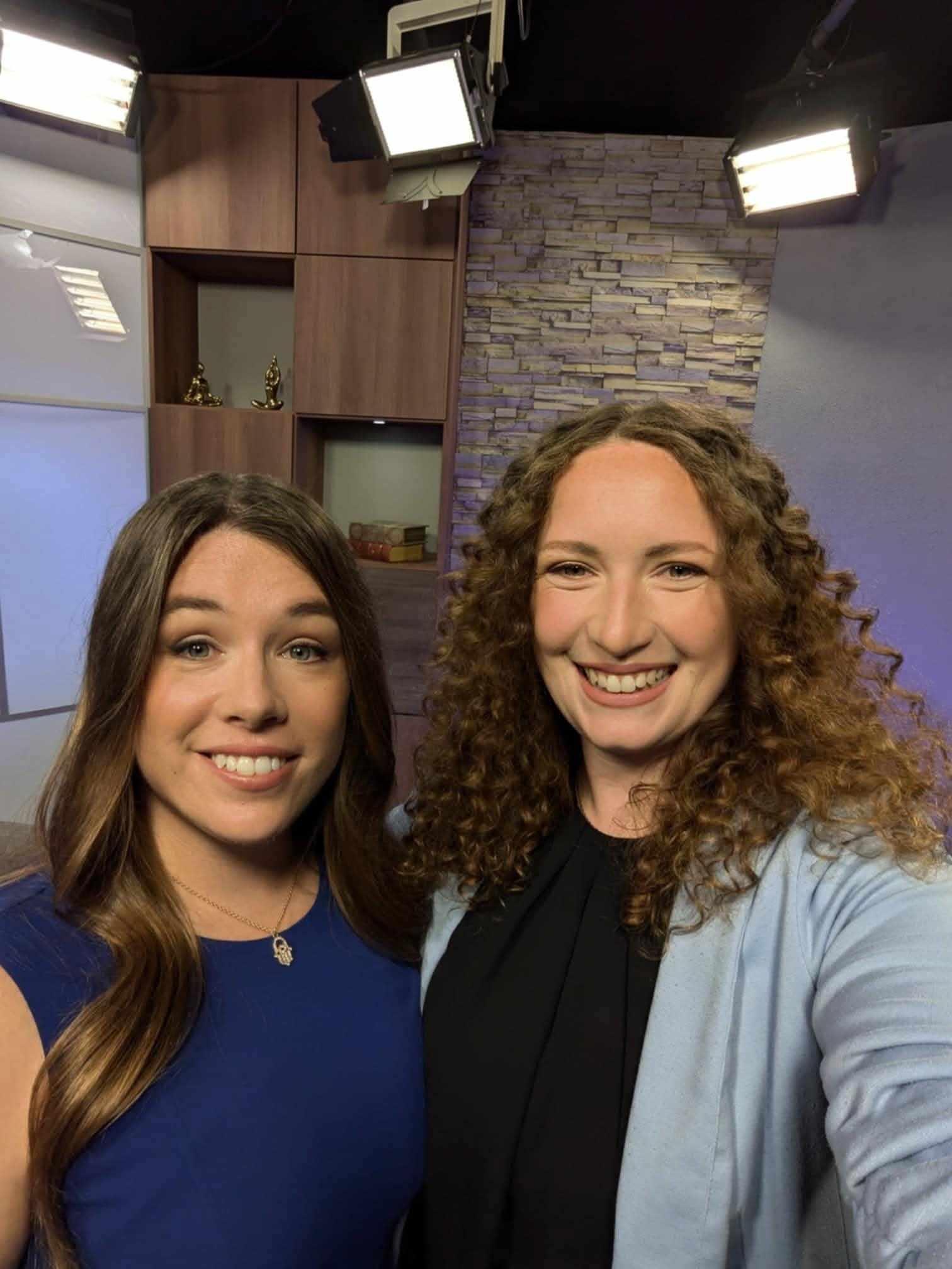 Stefanie and Chelsea of Stefsea Co. smiling together on a TV studio set